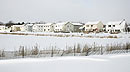 [houses near frozen pond]
