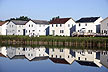 [houses reflecting in pond]
