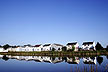 [houses reflection in pond]
